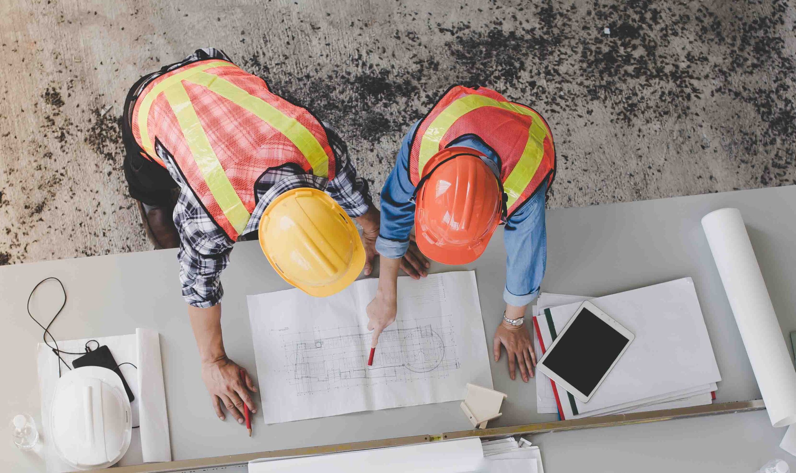 Top view of architects and engineers to help create a blueprint to build a modern building equipped with the skills to fix errors and make suggestions during construction.; Shutterstock ID 1062504653; purchase_order: -; job: -; client: -; other: -